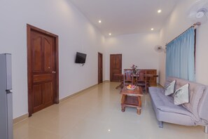 Family Deluxe Apartment | Living area | 32-inch flat-screen TV with cable channels, TV, fireplace - Aster Villa (Siem Reap)