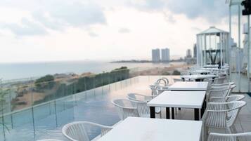 Outdoor pool, open 3:00 PM to midnight, pool umbrellas