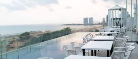 Outdoor pool, open 3:00 PM to midnight, pool umbrellas