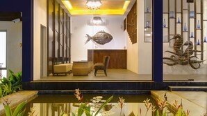 A modern house with a glass facade, a koi pond, and a wooden staircase. - KAI Hikkaduwa (Hikkaduwa)