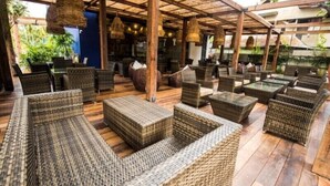 An outdoor seating area with wicker furniture and hanging lights. - KAI Hikkaduwa (Hikkaduwa)