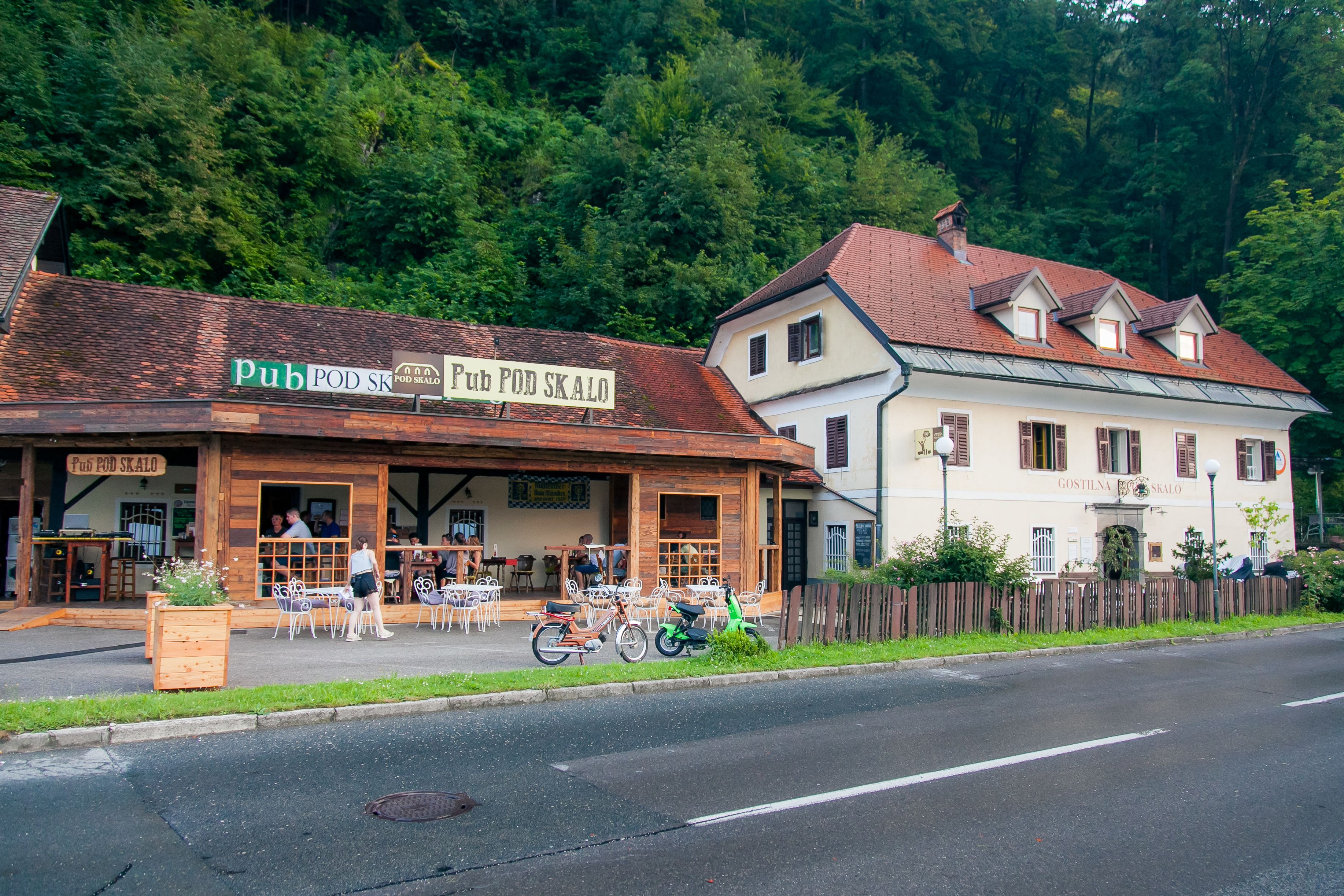 A pub with outdoor seating and a bicycle parked outside.