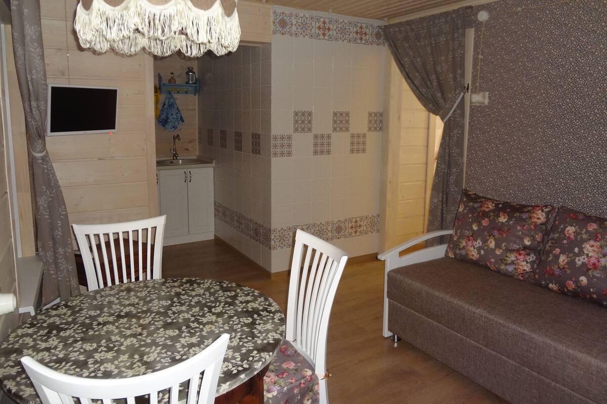 Family Quadruple Room, 2 Bedrooms, Kitchenette | Living room | Flat-screen TV