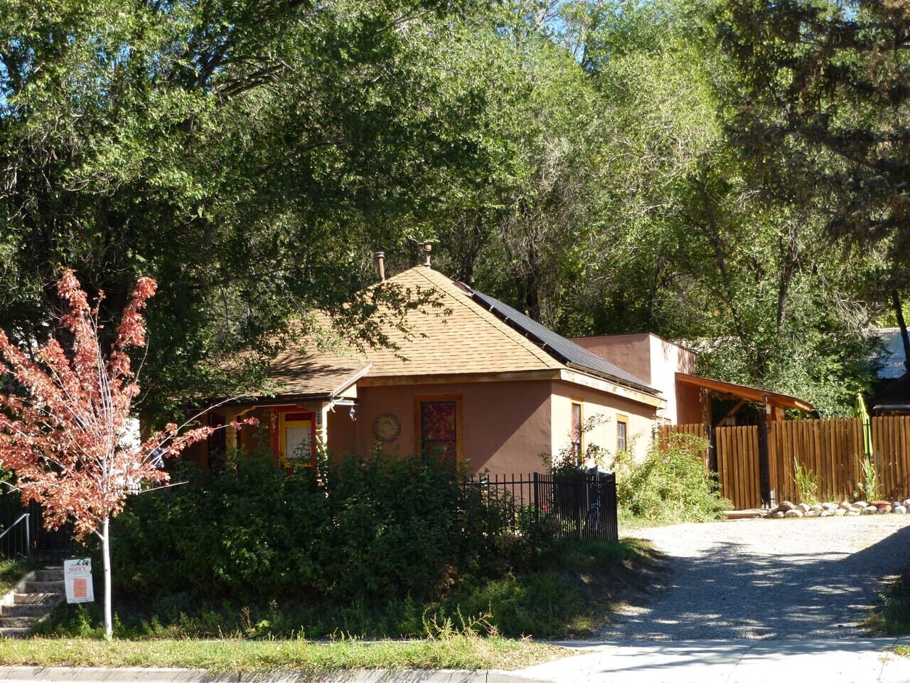 A single-story building with a brown roof and a small porch.