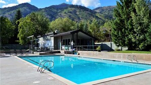 A swimming pool with a view of mountains in the background. - RMR: Four Seasons II Unit 1 Condo in Teton Village (Teton Village)