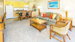 A compact living space with a kitchenette, a dining area, and a sofa. - 1BR condo w/ lanai & pool access (Honolulu)
