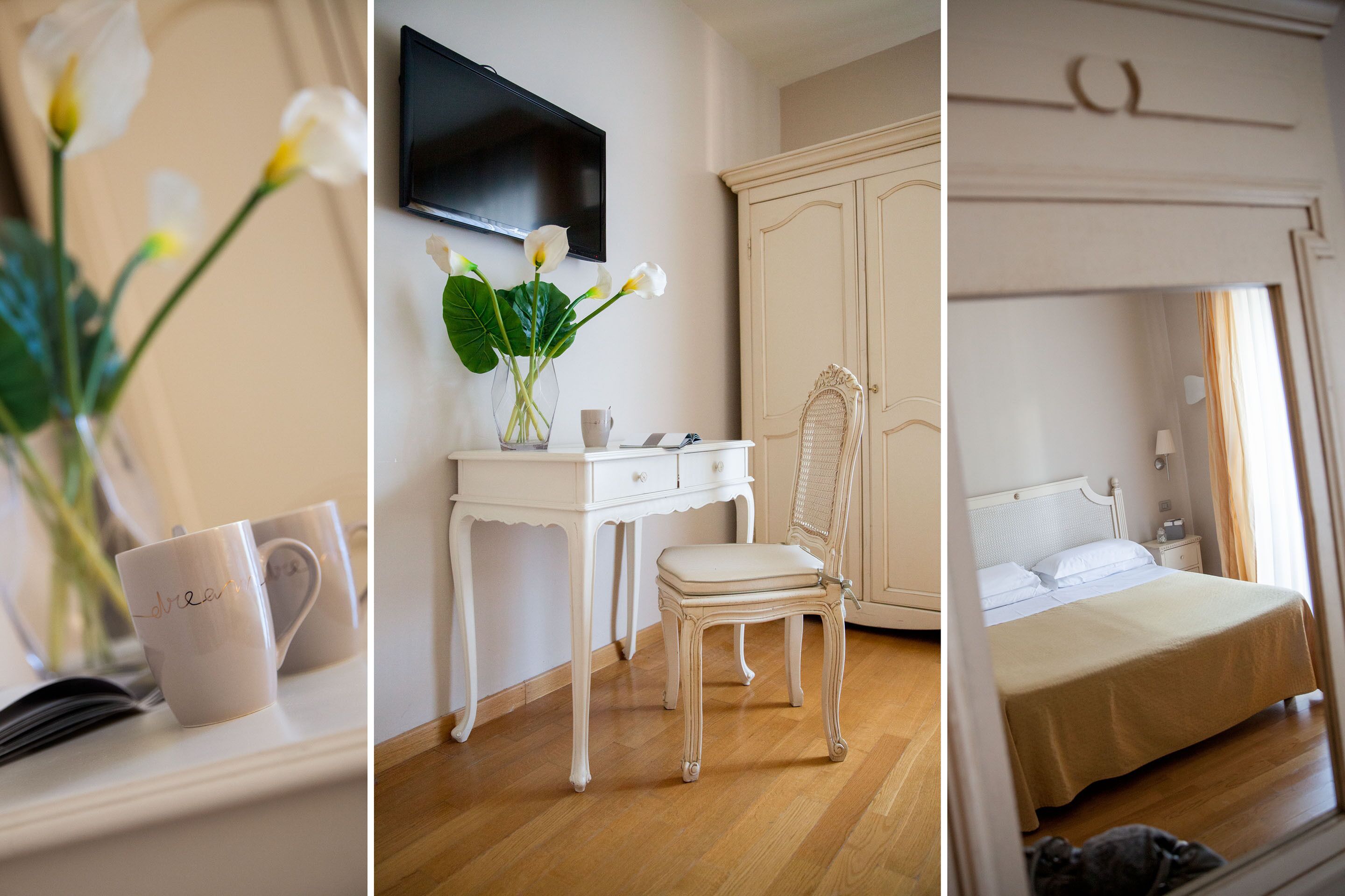 A bedroom with a bed, a dresser, a chair, and a TV mounted on the wall.