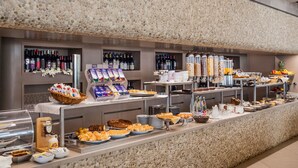 A buffet with various food items and beverages, including fruits, pastries, and a selection of wines. - Hotel Dei Fiori (Alassio)