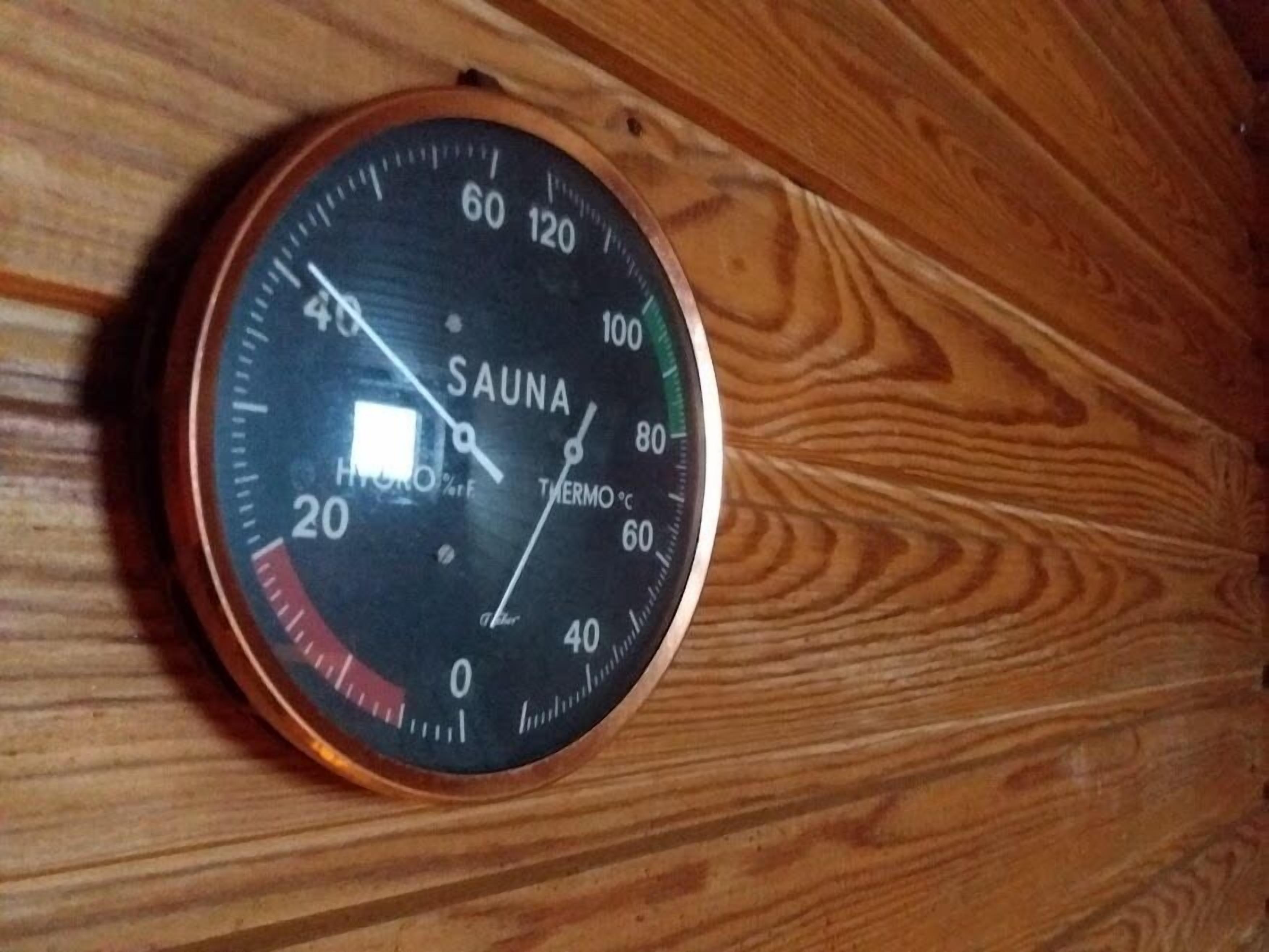 A sauna control panel with temperature and humidity settings.