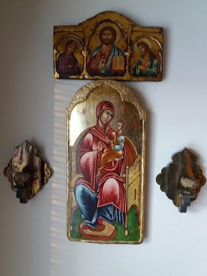 A religious icon with a central figure of a woman holding a child, flanked by two smaller figures. - Spacious 4 Room Apartment & Sauna (Kotka)