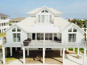Relax on the spacious balcony with a seating area overlooking the beach.