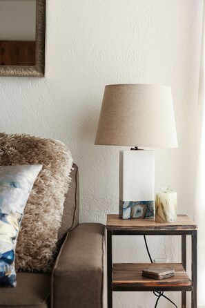 A room with a sofa, a lamp on a small table, and a mirror on the wall. - POW HAUS: Modern Beaver Creek 2BR w/ Ski Access (Avon)