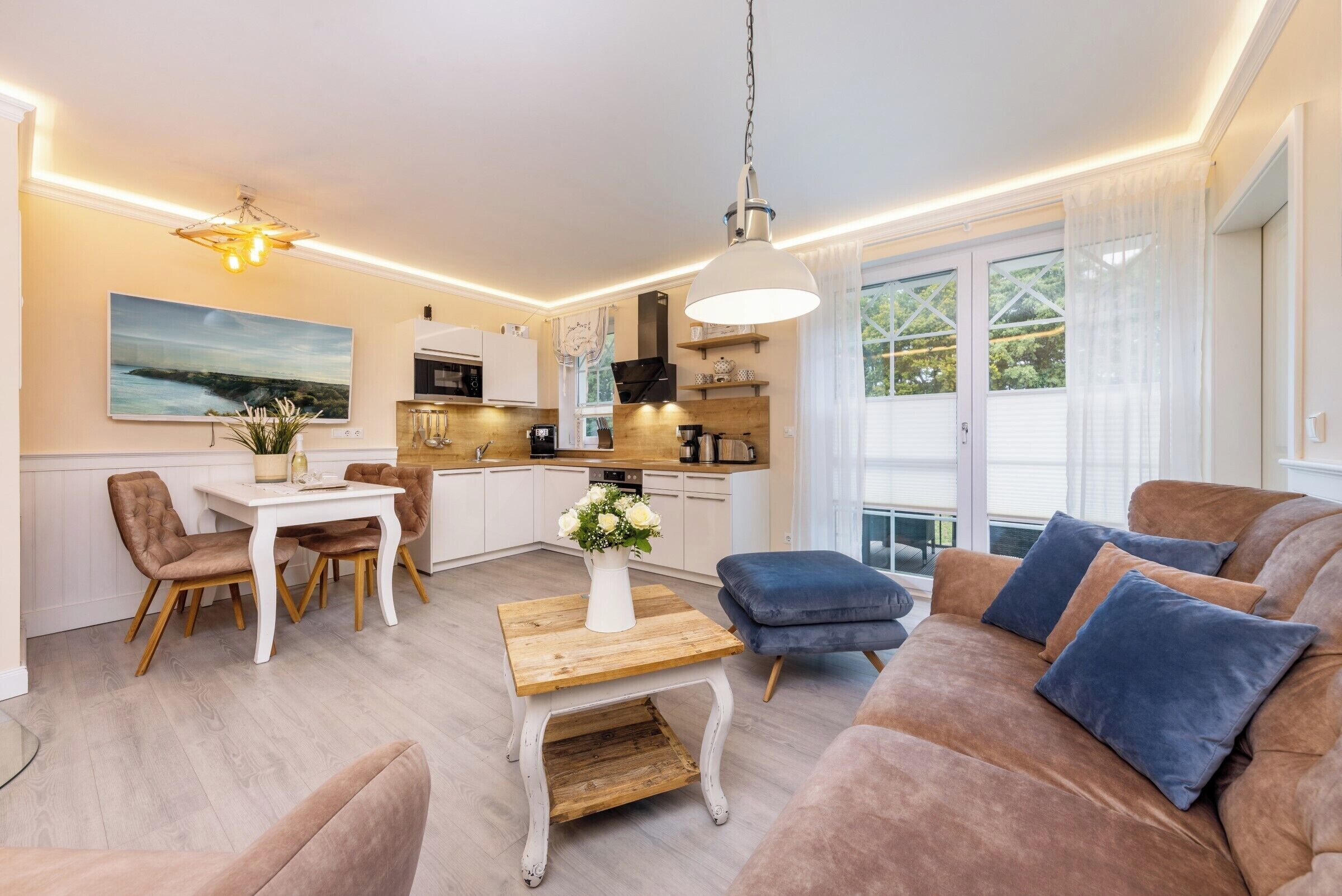 A modern living room with a sofa, coffee table, and dining area.