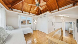 A bedroom with a wooden ceiling, a bed, a bedside table, a floor lamp, and a view of the outside. - P46 - Beautiful updated home on the Gulf side with pool and dock! (Marathon)