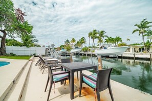A marina with boats docked, a pool, and outdoor seating. - P46 - Beautiful updated home on the Gulf side with pool and dock! (Marathon)