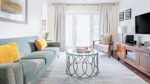 A living room with a sofa, a coffee table, a TV, and a cabinet. -  Downtown Napa!  Unit B Walk to Everything! (Napa)