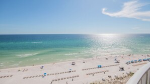 A beach with clear blue water, a sandy shore, and umbrellas. - OPEN 9/19-9/21 OR 9/26-10/1 GULF VIEW 12th floor Condo on the beach (Panama City Beach)