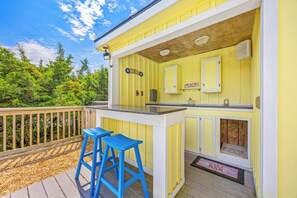Sip your morning coffee or enjoy an al fresco meal at this cheerful outdoor bar on the covered deck, complete with sink and refreshing views of the surrounding greenery. - Semi-Oceanfront Home w/ Pool, Hot Tub, Elevator, Cabana w/ Tiki Bar, Game Room (Salvo)