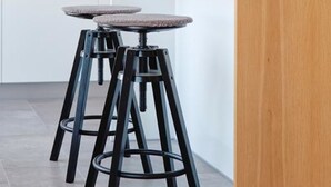A modern kitchen with a central island, two bar stools, pendant lighting, and a coffee machine. - Funky Flat (Sofia)