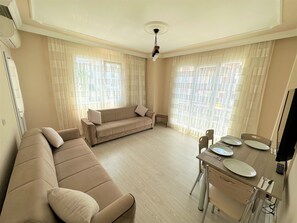 Premium Apartment, Garden View | Living area | Flat-screen TV - Cerrahpasa Apart Hotel (Trabzon)