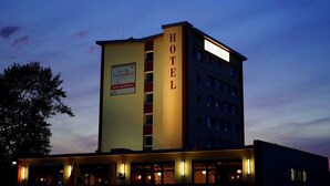 A hotel building with a prominent 'HOTEL' sign on the facade, a visible '24h geoffnet' sign, and a 'Europahotel' sign on the side. - Europa Hotel (Kehl)
