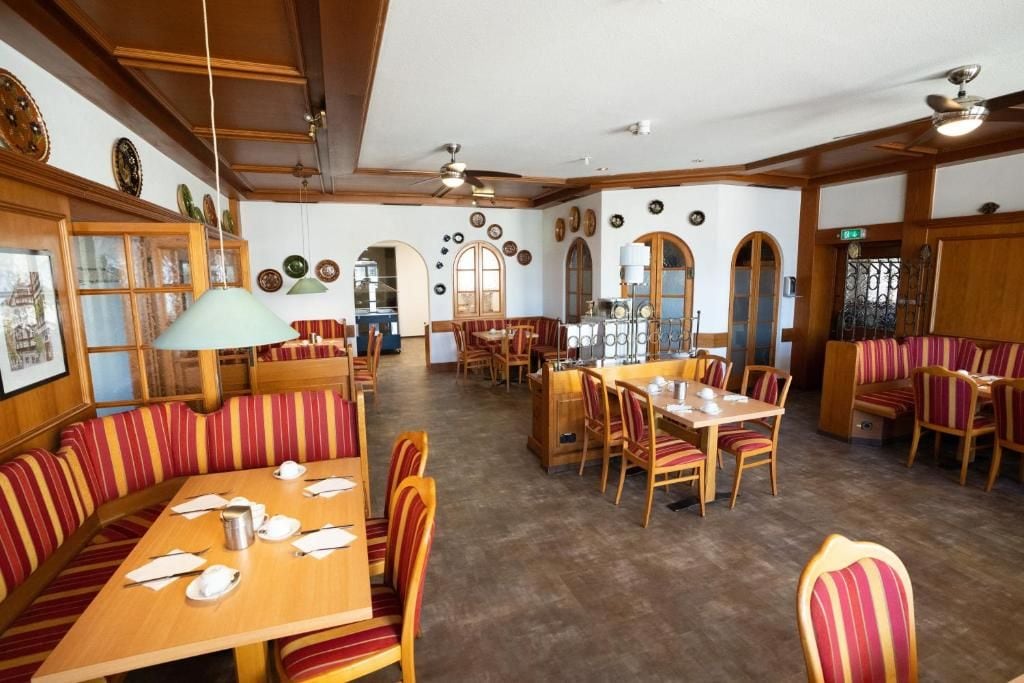 Un ristorante con arredi in legno, diversi tavoli e banconi.