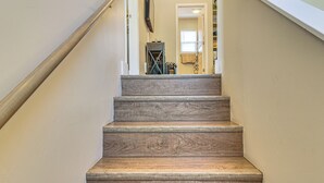 A wooden staircase with a handrail on the left, leading to a room with a door and a window. - 30 Mi to Crested Butte: Dog-Friendly Home By River (Gunnison)