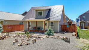 A residential house with a covered porch, a small deck, and a stone garden. - 30 Mi to Crested Butte: Dog-Friendly Home By River (Gunnison)