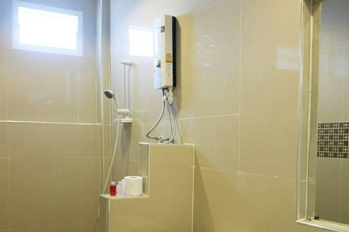 A bathroom with a toilet, a sink, and a shower.