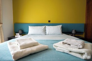 A hotel room with a bed, two bedside tables, a nightstand, and a wall-mounted light switch. - Private Villa with own pool 5 minutes drive to Coral Bay with 2 Sandy beaches (Paphos)