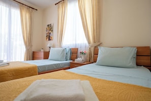A hotel room with two beds, a nightstand, a lamp, and a painting on the wall. - Private Villa with own pool 5 minutes drive to Coral Bay with 2 Sandy beaches (Paphos)