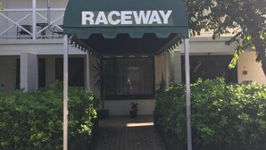 A building entrance with a green canopy labeled "RACEWAY". - Raceway Motel (Christchurch)