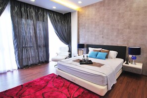 Cozy retreat with a neatly made bed, bedside table, and large window.