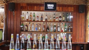 A bar with a wooden interior and a sign indicating '1800 Super Premium Tequila'. - Gili Lumbung Bungalow (Gili Air)