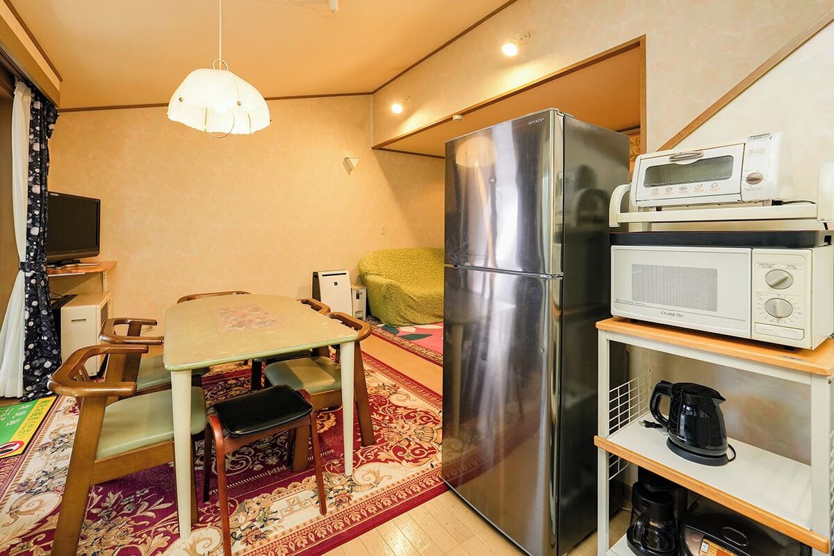 A compact kitchen with a refrigerator, microwave, and coffee maker.