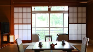A traditional Japanese room with tatami flooring, a low table, and cushions. - Yudanaka Yumoto (Yamanouchi)