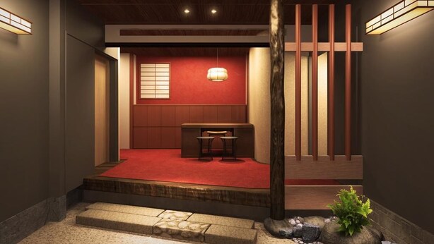 A traditional Japanese-style room with tatami flooring, a low wooden table, and a red carpeted entrance. - Ito Ryokan (Tokyo)