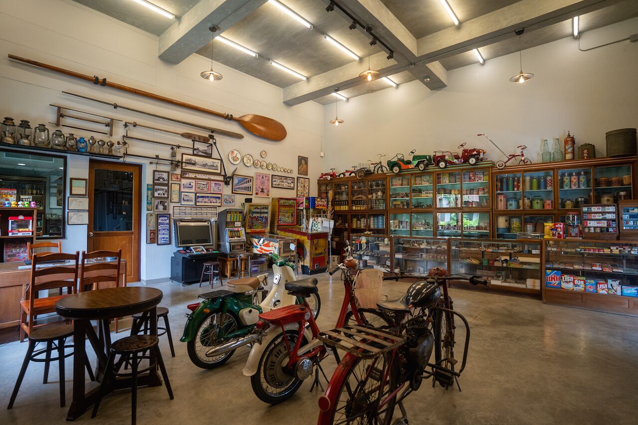A vintage-themed room with wooden furniture, a dining area, and a collection of bicycles and toys.