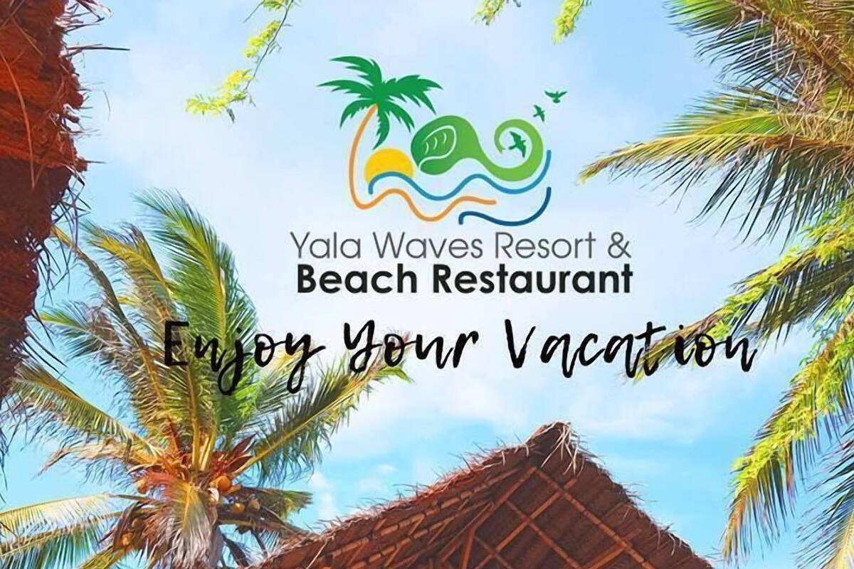 A wooden structure with a thatched roof, surrounded by palm trees, labeled as Yala Waves Resort & Beach Restaurant.