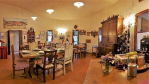 A spacious living room with a fireplace, dining area, and kitchen. - Borgo Caiano Country Inn (Castel San Niccolo)
