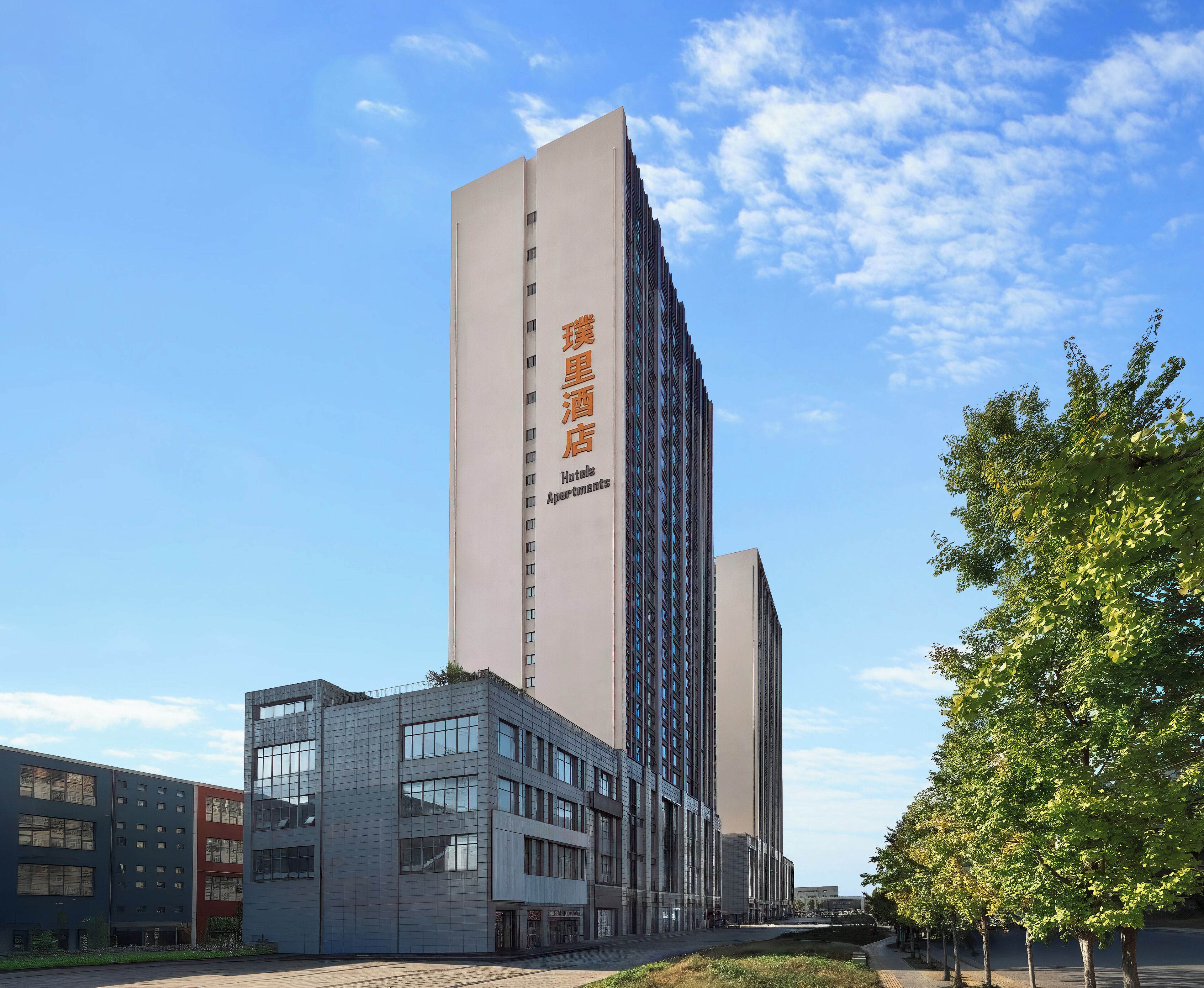 A modern hotel building with a prominent vertical sign indicating it is a hotel.