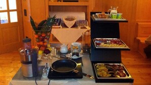 A breakfast buffet with various food items, a coffee maker, and a fruit bowl. - Relais Fior di Bosco (Folgaria)