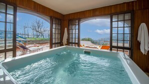 A large indoor swimming pool with wooden walls and large windows. - Elegant & Panoramic Villa with Sea View Solarium (Furore)