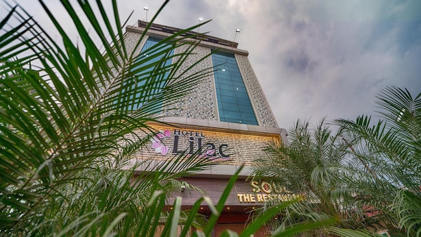 A hotel with a modern facade, large windows, and a prominent sign for 'Hotel Lilac'. - Hotel Lilac (Kota)