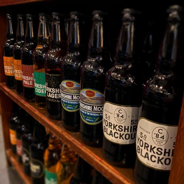 A shelf with various bottles of Yorkshire beer.