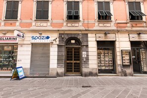 A building facade with a closed shop named "500ZI CELLULAR" and another named "PROGETTO IMMOBILIARE".
