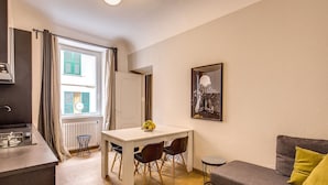 A compact living space with a kitchenette, a dining area, and a sofa. - Cinque Terre Decor (La Spezia)