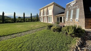 A modern building with a sign reading "Le Albare."