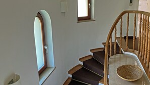 A staircase with wooden railings and a basket on the landing. - Absolutely quiet 3 Room Apartment "At Isar River Park",  near Munichs Centre (Grünwald)