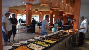 A buffet area with various food options and people dining. - Kaliakria Resort (Kavarna)
